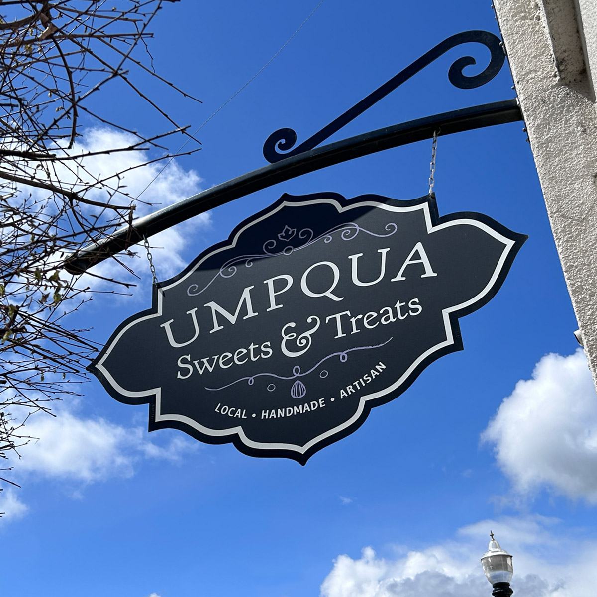 Custom made sign and bracket for Umpqua Sweets and Treats in Downtown Roseburg.