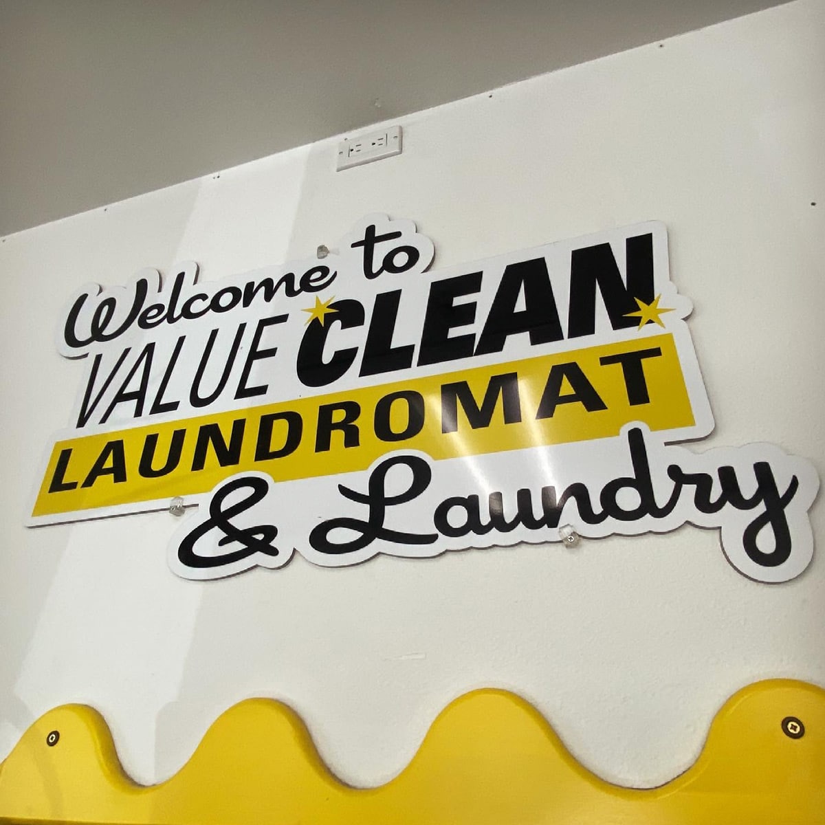 Value Clean Laundromat interior logo sign.